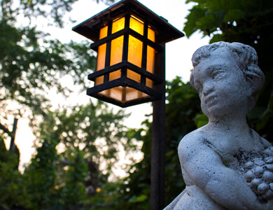 Path light beside a sculpture